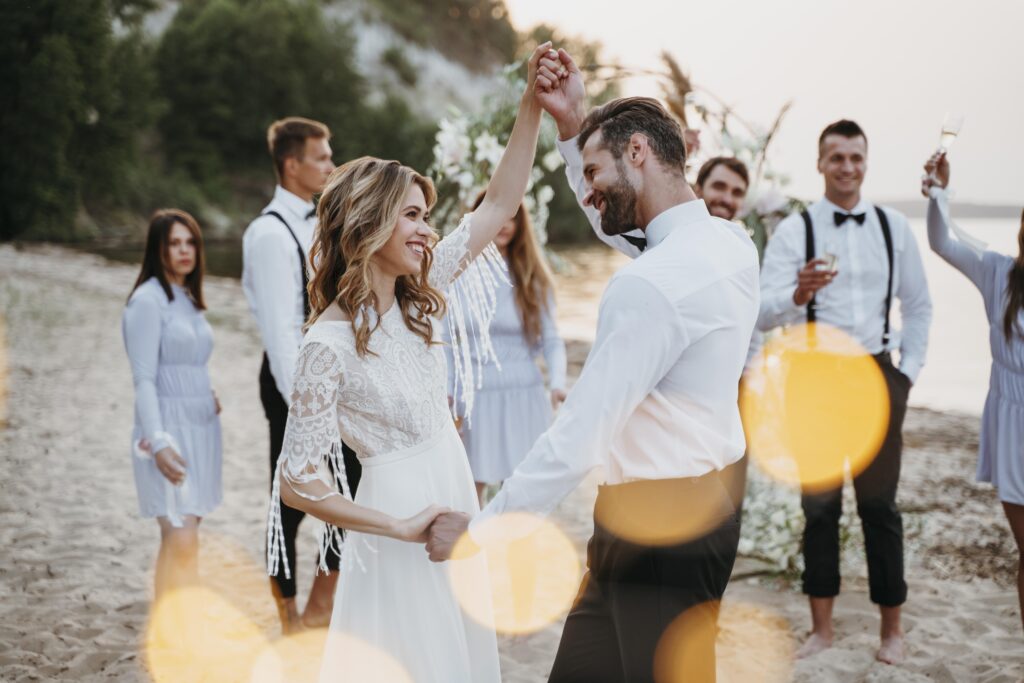 bride-groom-having-their-wedding-with-guests-beach (1)