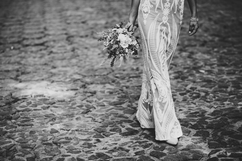 The bride's hand holds from below a wedding bouquet, a look at t