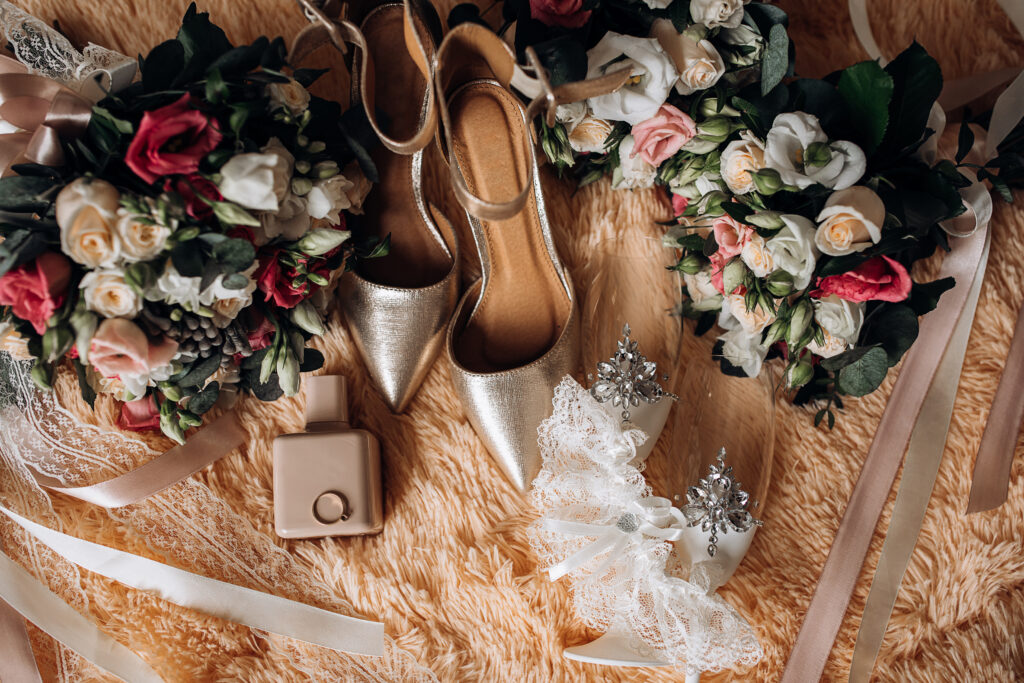 Silver wedding shoes, decorated traditional champagne glasses an